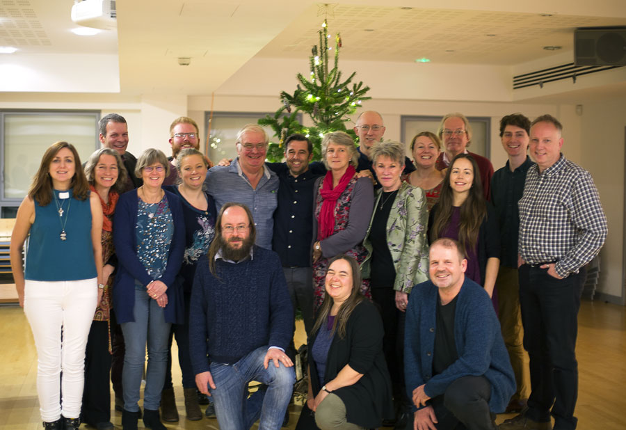 Group photo of graduating students and new lay pioneers in front of the Christmas tree