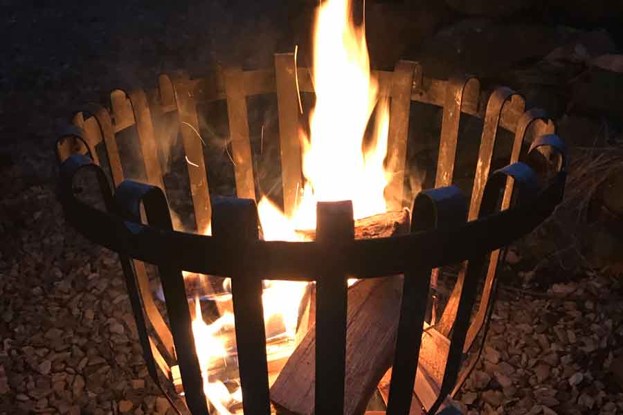 Flames shoot up from a brazier in the dark