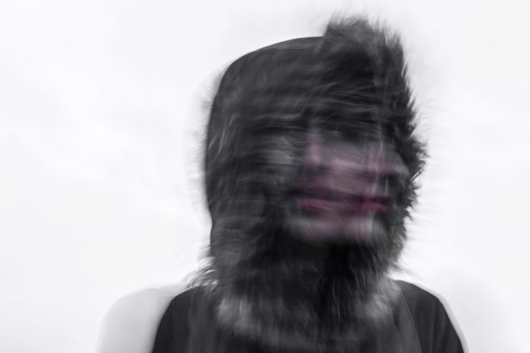 Blurred image capturing a face moving from side to side