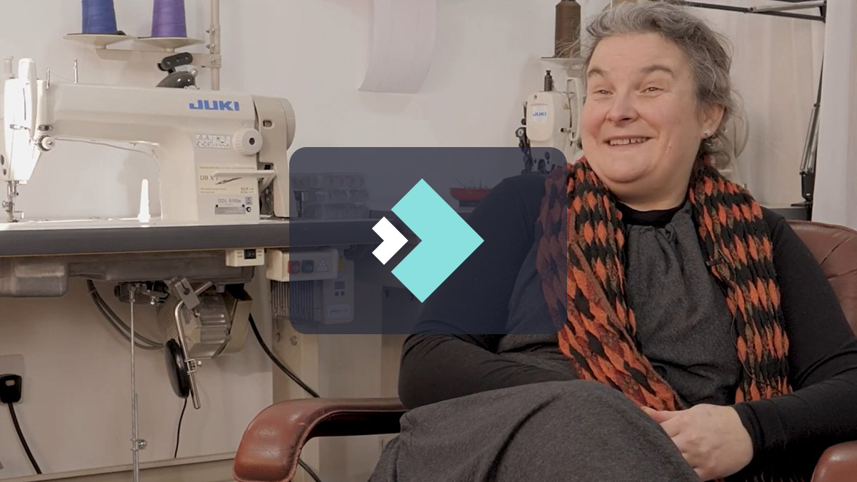 Video screenshot Maria Skoyles next to sewing machine