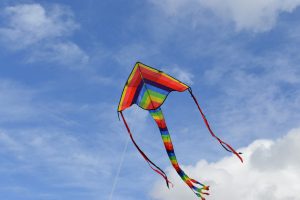 colourful kite flying against blue sky