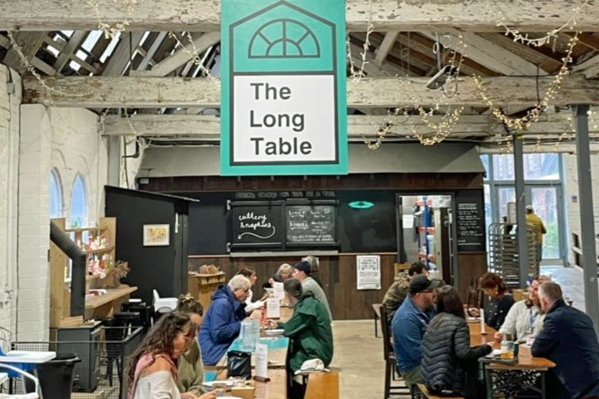 The Long Table cafe - customers sit at long tables in a barn setting